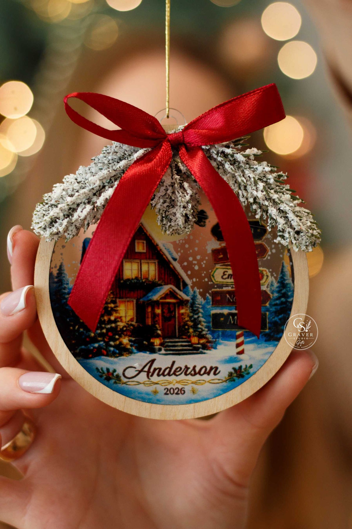 Personalized Christmas ornament with red bow and festive evergreen decoration